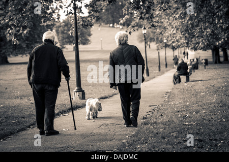 A senior couple walking on a path up Primrose Hill, London Stock Photo