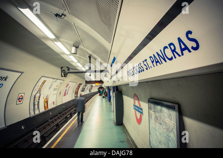 A man walking down the platform at Kings Cross St. Pancras tube station in London, United Kingdom Stock Photo