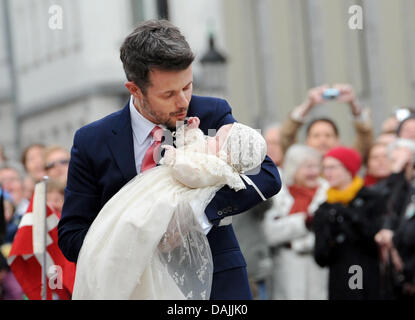 Danish Crown Prince Frederik holds one of his twins arriving for the christening and naming ceremony of the Danish twins at the Holmens Kirke (Holmens church) in Copenhagen, Denmark, 14 April 2011. The twins of Crown Prince Frederik and Princess Mary, a boy and a girl, were born on January 8, 2011. Photo: Christian Charisius Stock Photo