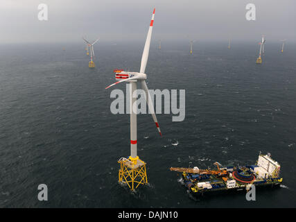 (dpa File) - An archive picture, dated 12 November 2009, shows a rigging vessel anchoring next to a wind turbine in Germany,s first offshore wind park near the island of Borkum, Germany.  Photo: Ingo Wagner Stock Photo