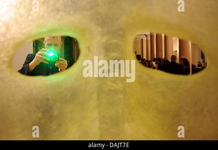 A man photographs the artwort 'Cameron' by artist Patrick Tuttofuoco at the Italian Embassy in Berlin, Germany, 28 April 2011. 44 galleries are taking part in 'Gallery Weekend Berlin' this year. Photo: Britta Pedersen Stock Photo