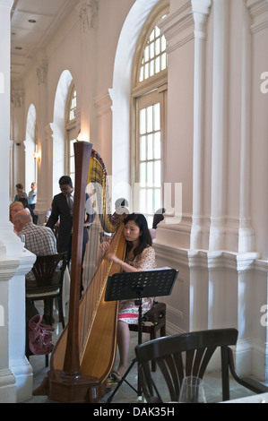 dh Tiffin Room RAFFLES HOTEL SINGAPORE Harpist playing to afternoon tea customers harp player interior Stock Photo