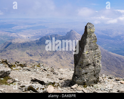 Stone marker at top of Watkin path on Mt Snowdon with view to Y Lliwedd in Snowdon horseshoe in mountains of Snowdonia Wales UK Stock Photo
