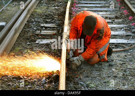 railway worker cutting with blowpipe a railway track, Germany Stock Photo