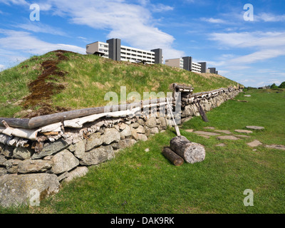 Reconstructed iron age longhouses on archaeological site in Ullandhaug Stavanger Norway, next to modern apartment houses Stock Photo