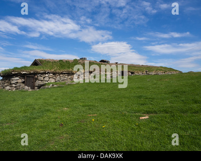 Reconstructed iron age longhouses on archaeological site in Ullandhaug Stavanger Norway, next to modern apartment houses Stock Photo