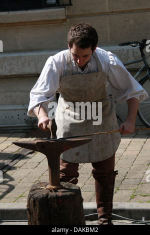 Blacksmith Demonstrating Medieval Method of Iron Working, Joan of Arc Festival, Reims, Marne, Champagne-Ardennes, France. Stock Photo