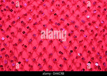 Net with Square Sequins above the cloth background Stock Photo