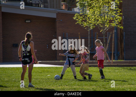 A female soccer coach instructs elementary schoolgirls during afternoon practice in Leeds, Utah. Stock Photo