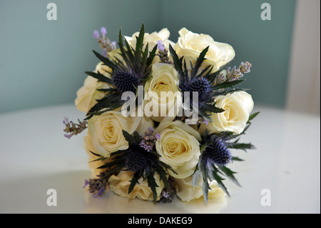 Wedding bouquet of white roses and purple heather Stock Photo