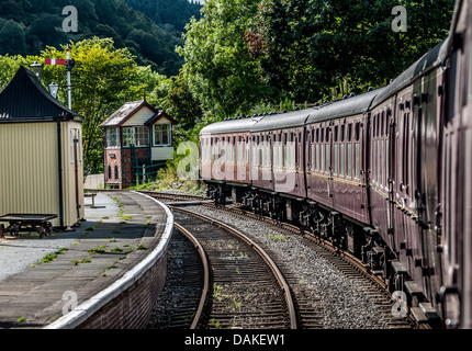 Old train carriages at a station platform with old signal boxes. Stock Photo