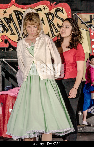 In 1950's clothing, Sandy Dumbrowski (left) and Rizzo talk at Rydell High School in a student production of the musical 'Grease' Stock Photo