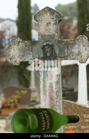 empty wine bottle on a grave Stock Photo