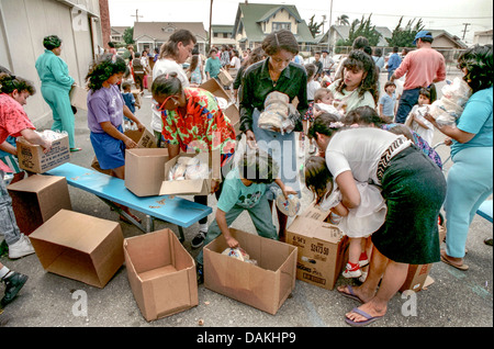Hungry Hispanic and African American local LA residents fight over free charity food after the 1992 Rodney King race riots. Stock Photo
