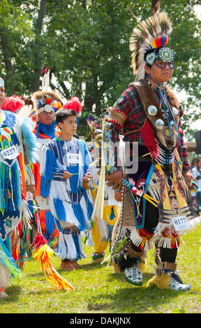 The proud Mohawk nation living in Kahnawake native community located on the south shore of the St Lawrence river in Quebec Canada celebrates it's annual Pow-Wow with traditional dances and drum music Stock Photo