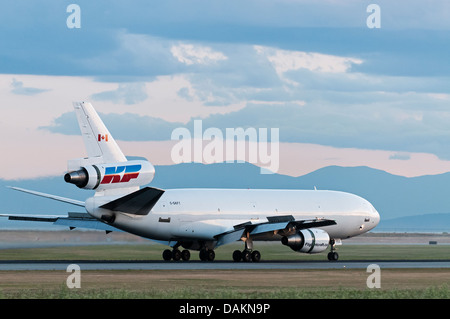 A Kelowna Flightcraft Air Charter Ltd. McDonnell Douglas DC-10-30F air cargo freighter lands at Vancouver International (YVR). Stock Photo