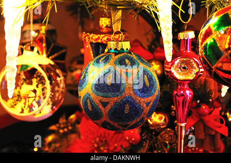 Colourful glass Christmas globes hanging on a Christmas tree. Stock Photo