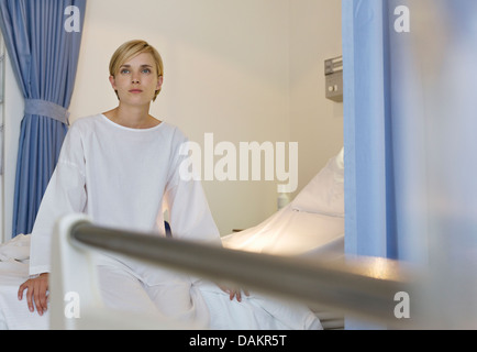 Patient sitting on hospital bed Stock Photo