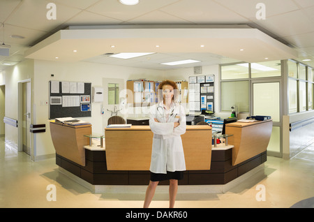 Doctor standing in hospital hallway Stock Photo