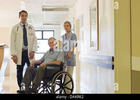 Doctor and nurse with older patient in hospital Stock Photo