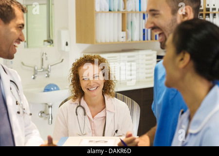 Hospital staff talking at desk Stock Photo
