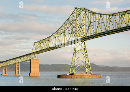 Classic portrait of Astoria-Megler Bridge front-lit in warm evening winter sunlight, with Columbia River. Space for copy. Stock Photo