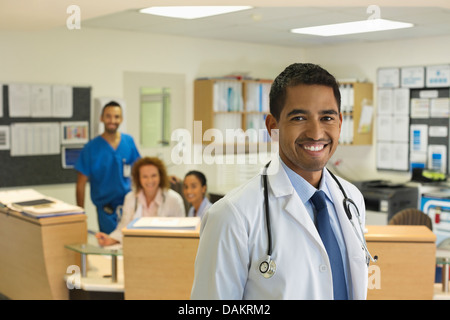 Doctor smiling in hospital hallway Stock Photo