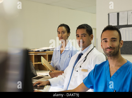 Hospital staff standing behind front desk Stock Photo
