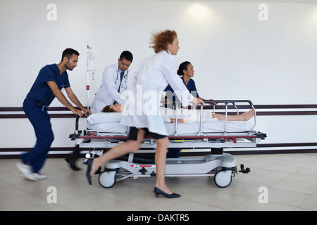 Hospital staff rushing patient to operating room Stock Photo