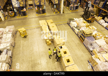 Workers talking in warehouse Stock Photo