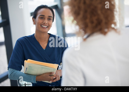 Nurse and doctor talking in hospital Stock Photo