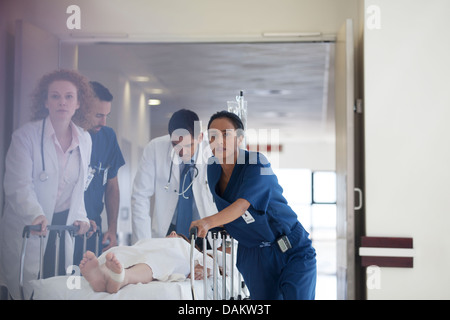 Hospital staff rushing patient to operating room Stock Photo