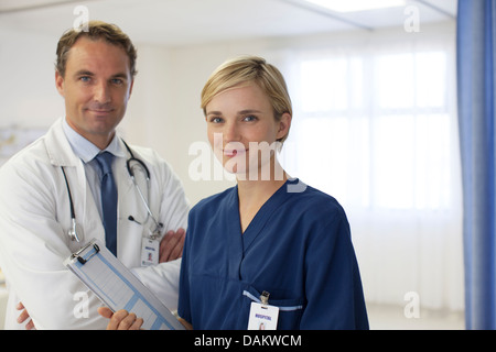 Doctor and nurse smiling in hospital Stock Photo