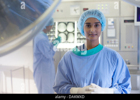 Surgeon standing in operating room Stock Photo