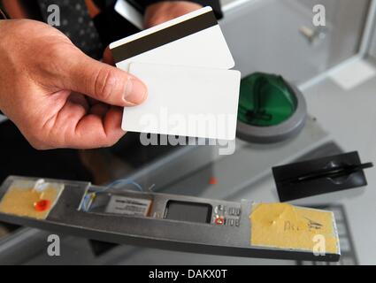 A ploice officer of the BKA demonstrates how cash machines can be ...