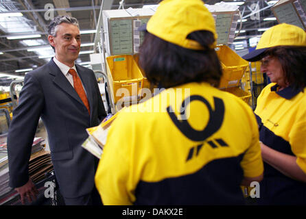 (FILE) - A file picture dated 27 April 2011 of Deutsche Post and DHL CEO Frank Appel (L) at the distribution centre in Troisdorf near Bonn, Germany. The boom in parcel and cargo business has spured the Deutsche Post at the beginning of the year. The turnover in the first quarter increased by 7 percent to 12.8 billion euro. The operating profit (EBIT) increased by 23 percent to 629  Stock Photo