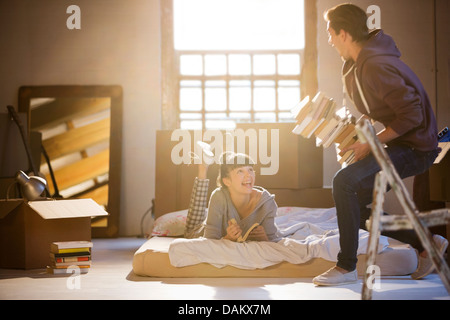 Couple relaxing in attic Stock Photo