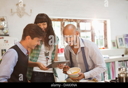 Friends relaxing together in kitchen Stock Photo