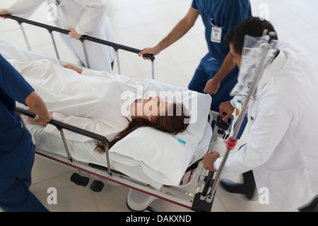 Hospital staff rushing patient to operating room Stock Photo