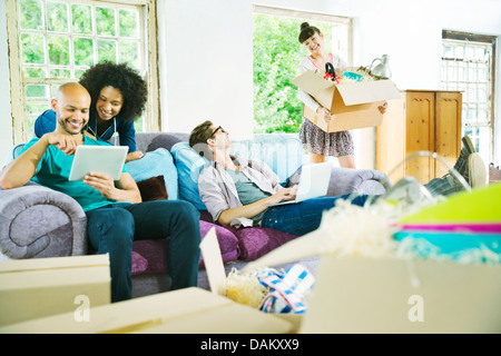 Friends relaxing together in new home Stock Photo