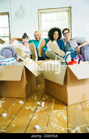 Friends relaxing in new home Stock Photo