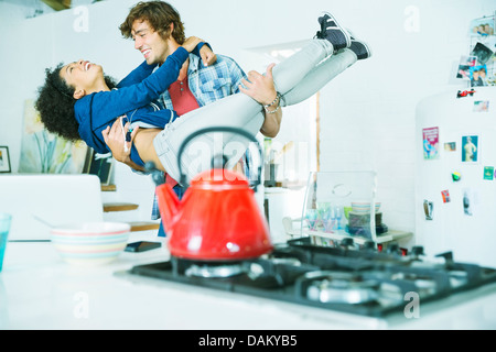 Couple playing together in kitchen Stock Photo