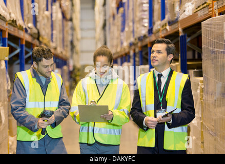 Workers talking in warehouse Stock Photo