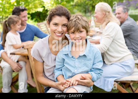 Mother and son smiling in backyard Stock Photo
