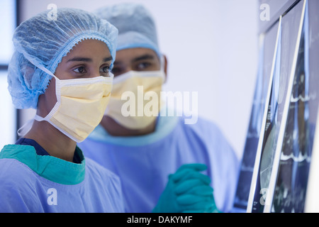 Surgeons examining x-rays in hospital room Stock Photo