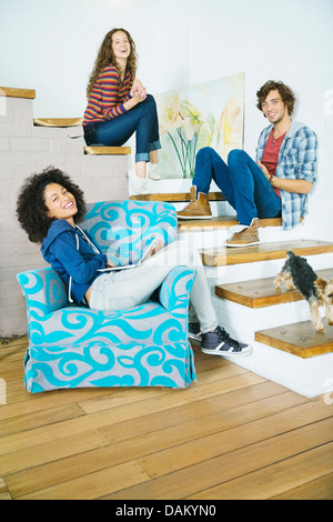 Friends relaxing together on steps Stock Photo