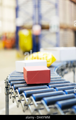 Packages on conveyor belt in warehouse Stock Photo