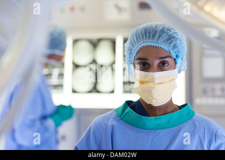 Surgeon standing in operating room Stock Photo
