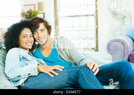 Couple relaxing together on sofa Stock Photo