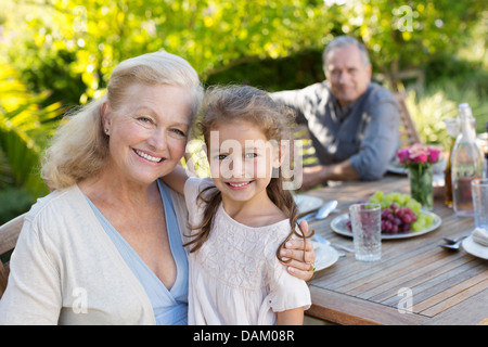 Older woman and granddaughter smiling outdoors Stock Photo